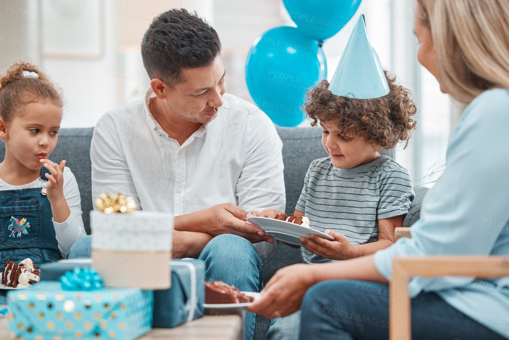 Buy stock photo Birthday, cake and food with family in living room for celebration, balloons and milestone event. Gift giving, love and support with people and party at home for growth, care and gathering together