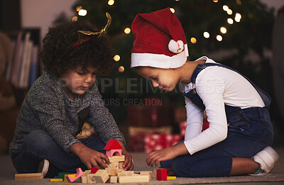 Buy stock photo Shot of two little siblings playing with blocks together at home
