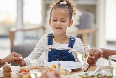 Buy stock photo Shot of a little girl closing her eyes for prayer time before lunch at home with her family