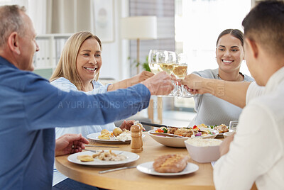 Buy stock photo Shot of a family toasting with wine while having lunch together at home