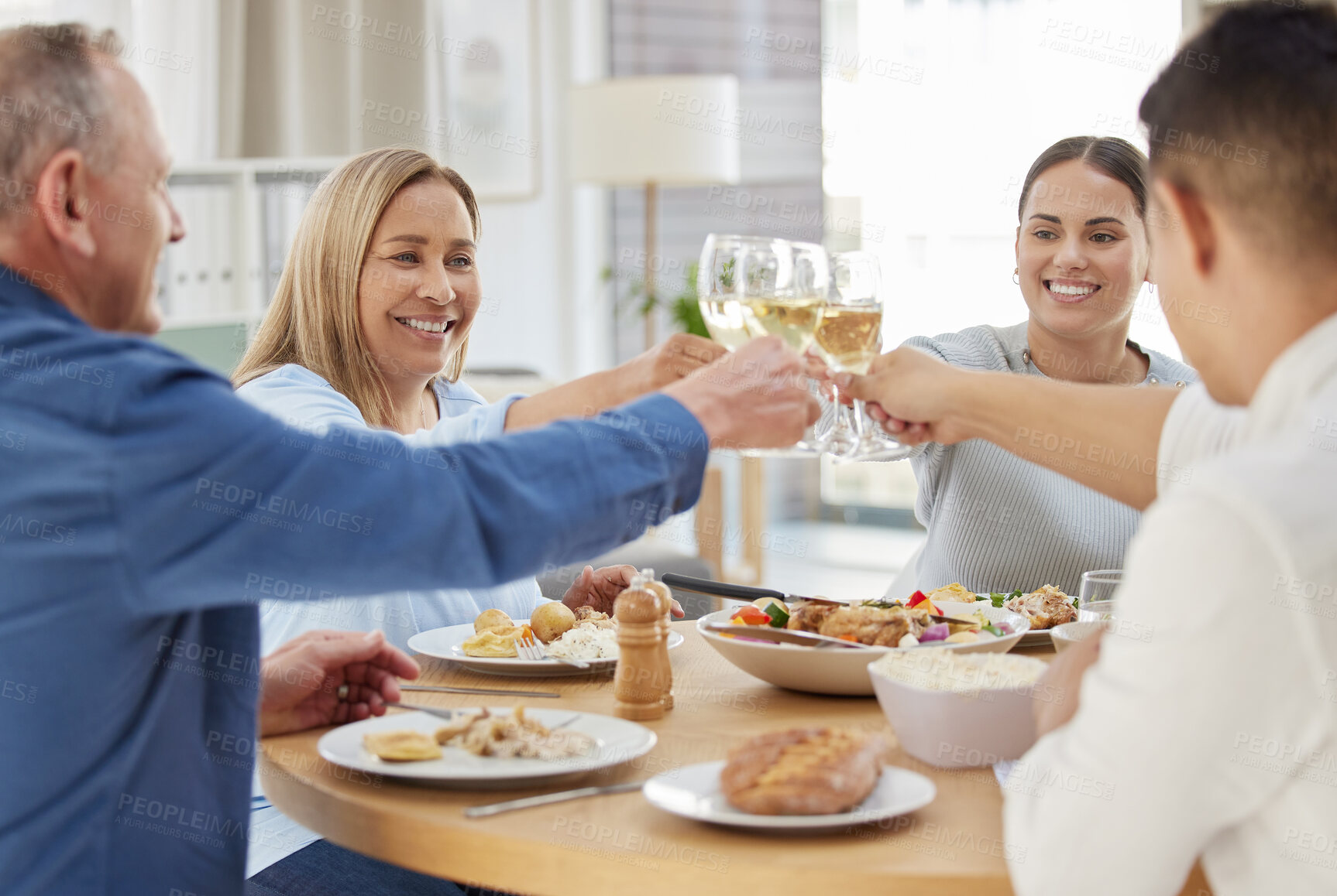 Buy stock photo Home, people and lunch with alcohol for cheers, celebrate and bonding together for thanks giving. Toast, men and women as happy family with food, fine dining and support with glasses of champagne