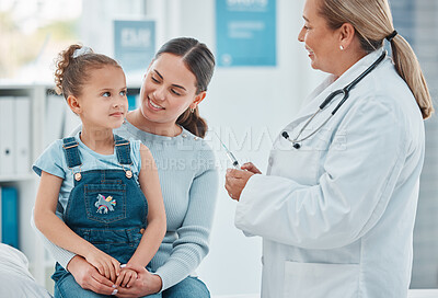 Buy stock photo Shot of a doctor administering an injection to a little girl in a clinic