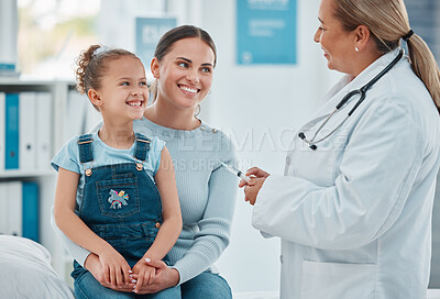 Buy stock photo Shot of a doctor administering an injection to a little girl in a clinic
