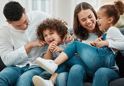 Buy stock photo Sofa, mother and father with children for laughing, connection and playful with game at home. Dad, mom and kids with tackle for bonding together, childhood and relax with happiness on couch in lounge