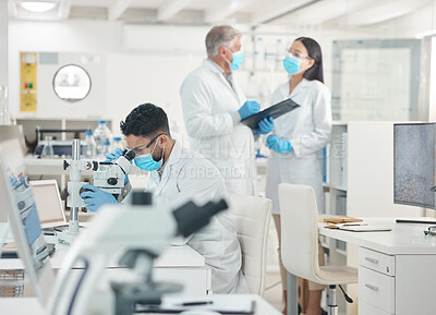 Buy stock photo Analysis, scientist and man in lab, microscope and medical research for MERS, talking and vaccine. Glasses, PPE and people with face mask in clinic, pharmaceutical and report for test and disease