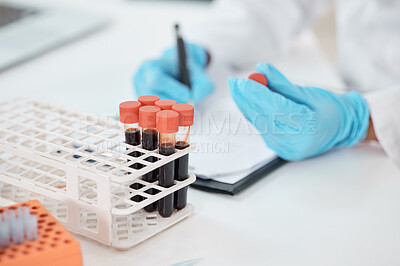 Buy stock photo Closeup shot of an unrecognisable scientist writing notes while working with samples in a lab