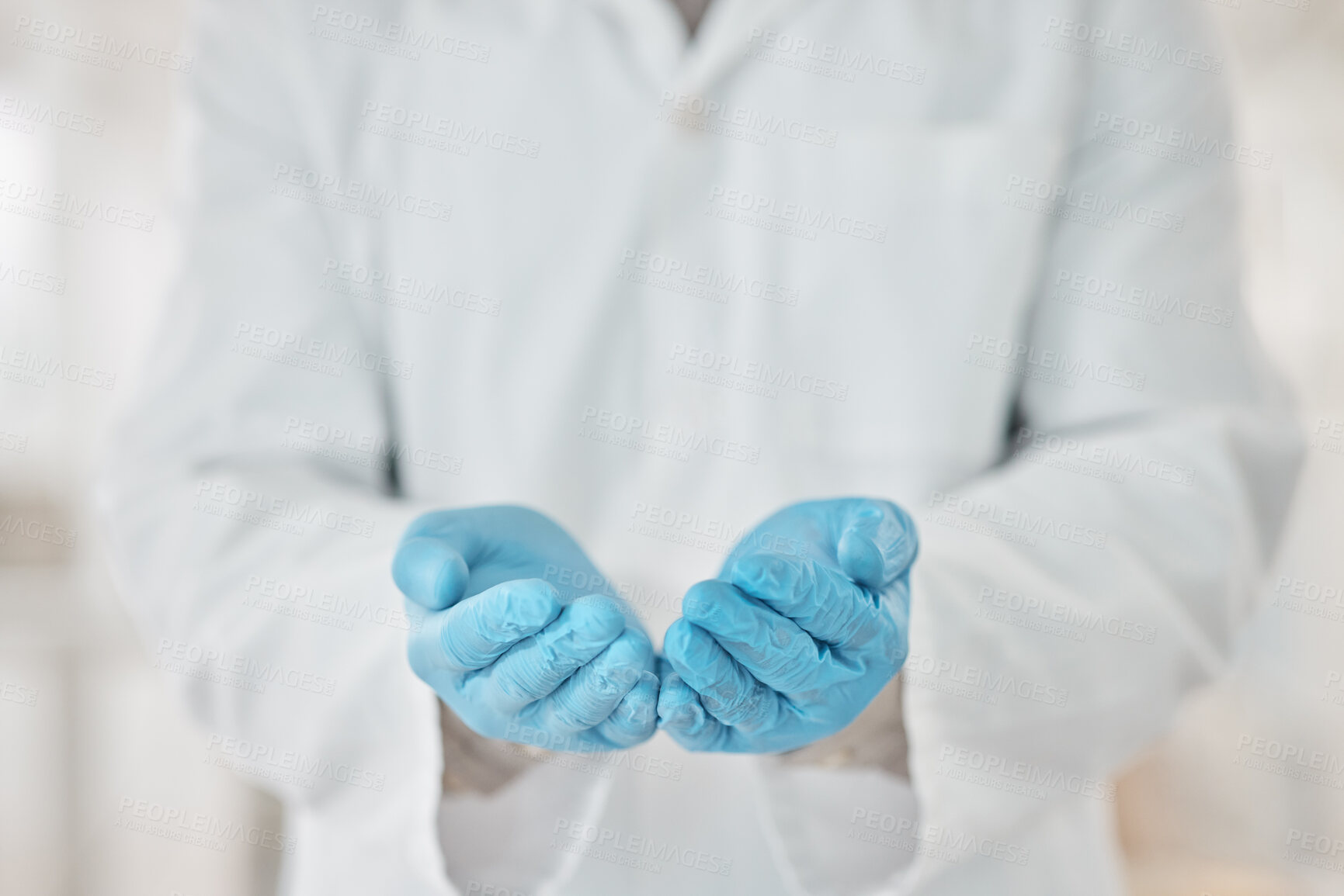 Buy stock photo Closeup shot of an unrecognisable scientist standing with their hands cupped together in a lab