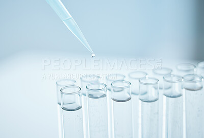Buy stock photo Closeup shot of a dropper being used to fill test tubes in a lab