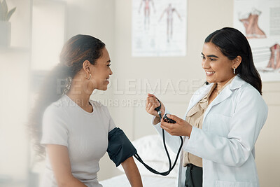 Buy stock photo Doctor, blood pressure and patient in a consultation, wellness checkup and appointment with diagnosis, talking and results. Healthcare, woman and medical physician with cuff for hypertension or test