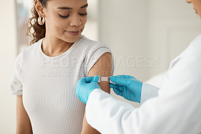 Buy stock photo Shot of an unrecognisable doctor applying a band-aid after injecting her patient during a consultation in the clinic