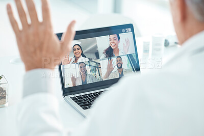 Buy stock photo Cropped shot of an unrecognisable doctor sitting in his clinic and using his laptop for a conference call