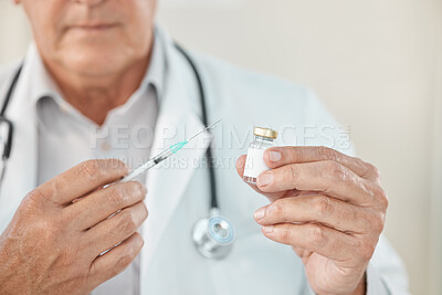 Buy stock photo Cropped shot of an unrecognisable doctor holding a syringe and vaccine in his clinic