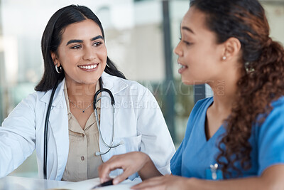 Buy stock photo Shot of two female medical professionals having a meeting together