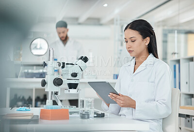 Buy stock photo Woman, scientist and tablet in laboratory with reading, studying and thinking for innovation by microscope. Person, digital touchscreen and review with pharmaceutical development for mpox vaccine