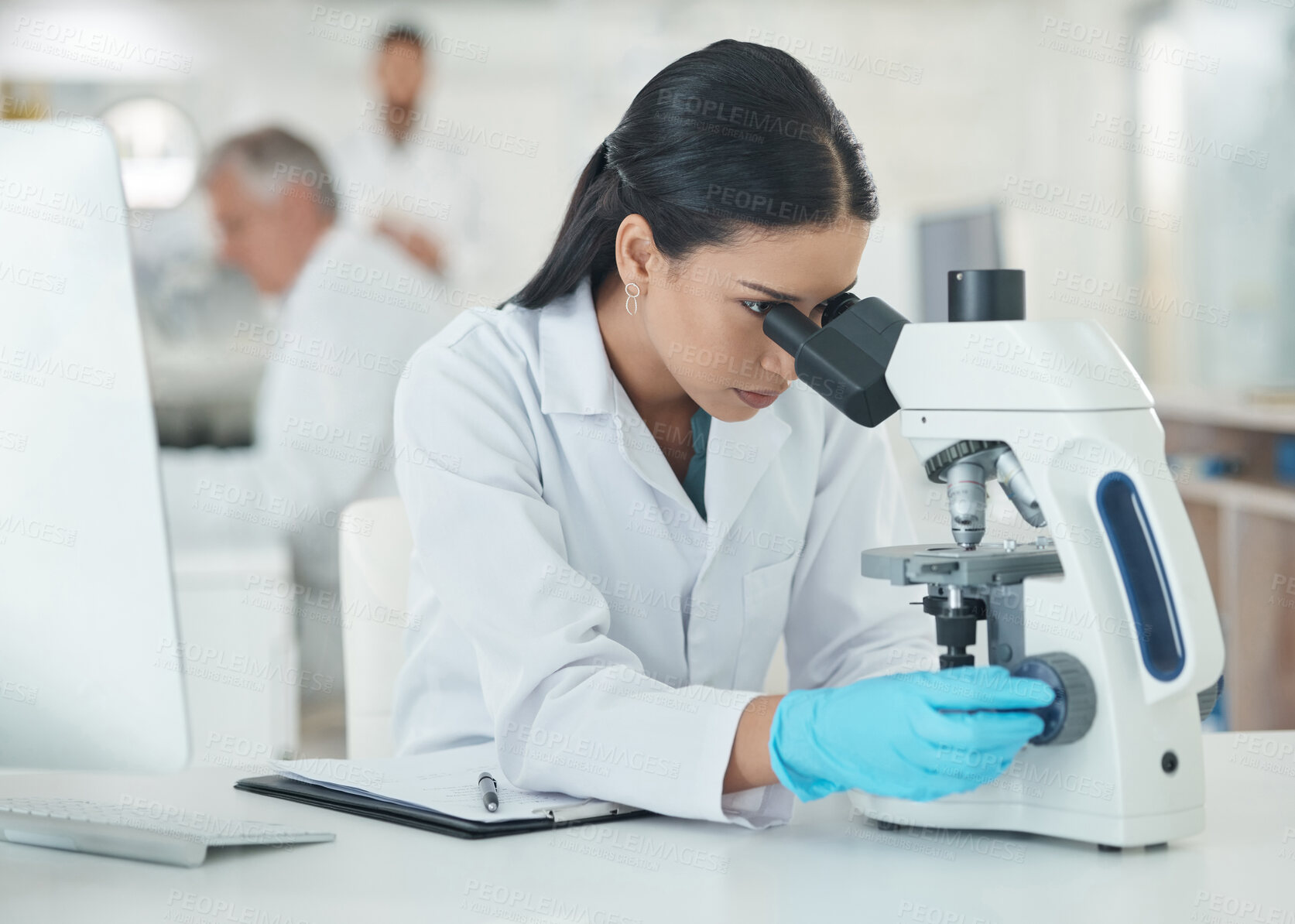 Buy stock photo Science, woman and microscope research with medical analysis in clinic laboratory. Chemistry, testing and hospital staff for monkeypox vaccine and scientist work with ppe gear for virus study