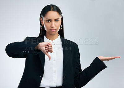 Buy stock photo Business woman, portrait and thumbs down with advertising space, negative review and mockup in studio. Female employee, hand and rejection sign for fail, poor service and feedback by gray background