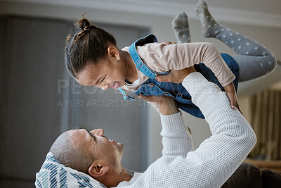 Buy stock photo Shot of a father and daughter bonding while playing on the sofa at home