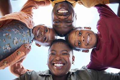 Buy stock photo Shot of a young family of four standing together in a huddle