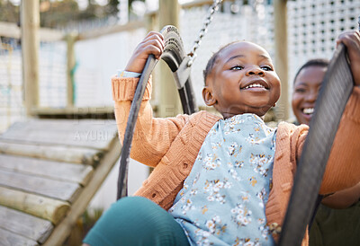 Buy stock photo Shot of a little girl having fun on a swing