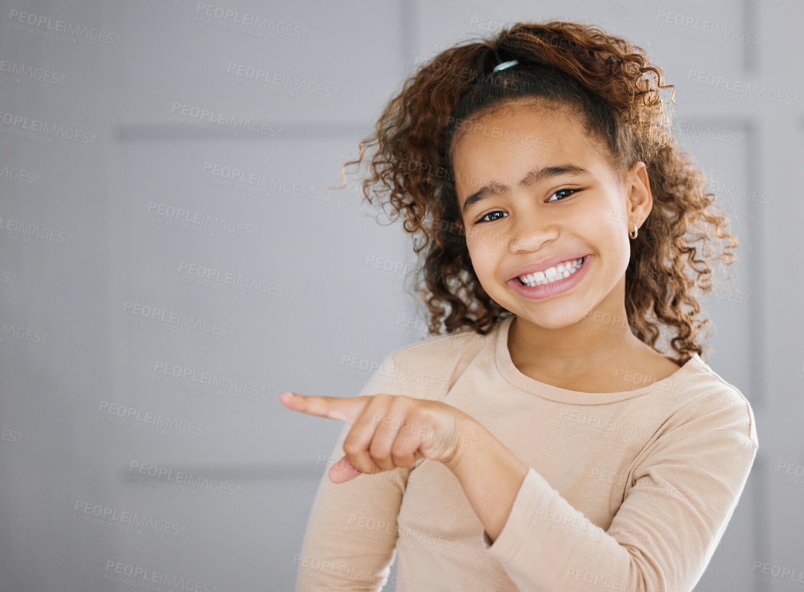 Buy stock photo Portrait, girl and pointing with smile, mockup space and happy in home for promo, advertising or copyspace. Young, female person and update for brand, logo or announcement with gesture, pride or kid