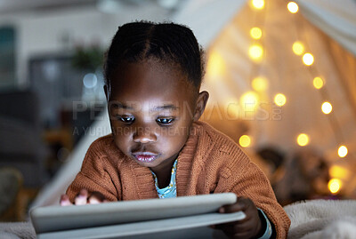 Buy stock photo Black, girl and tablet to relax at night for streaming story online, watch movie and website for game in tent bedroom. African, child and scroll with digital for cartoon subscription at house