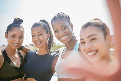 Buy stock photo Shot of a group of friends taking selfies on the beach during a workout