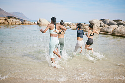 Buy stock photo Beach, running and group of women in water for fun holiday, outdoor adventure and bonding from back. Ocean, nature and girl friends playing in waves on travel vacation together on tropical island.