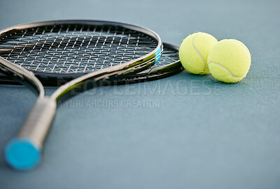 Buy stock photo Shot of two tennis rackets and tennis balls on a court during the day