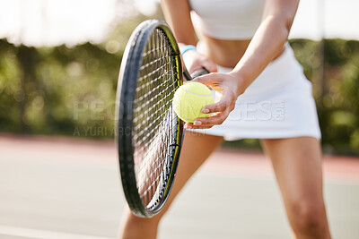 Buy stock photo Cropped shot of an unrecognisable tennis player standing on the court and getting ready to serve during practice