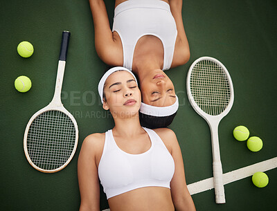 Buy stock photo Shot of two tennis players lying next to each other
