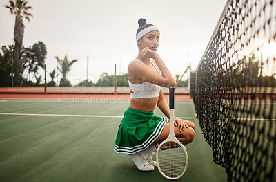 Buy stock photo Shot of a sporty young woman playing tennis on a court