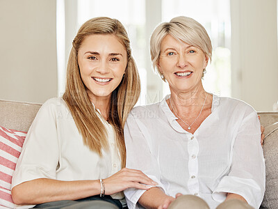 Buy stock photo Shot of a mother and daughter sitting on the couch at home