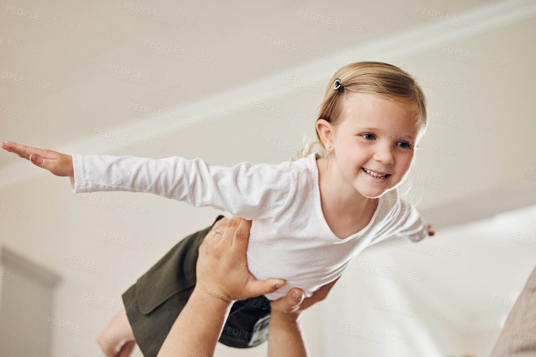 Buy stock photo Girl, child and flying on hand for game in home with imagination, playing and support with smile. Kid, airplane fantasy and balance with trust, enjoyment and bonding with lifting and freedom in house