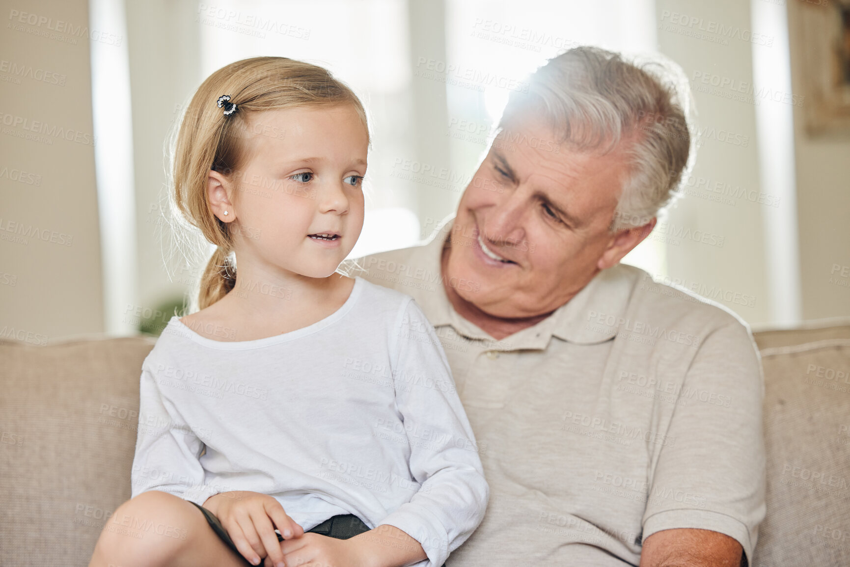 Buy stock photo Family, home and grandpa with girl on sofa for connection, care and bonding together on weekend. Smile, senior man and relax with grandchild in living room for love, happiness and support in growth