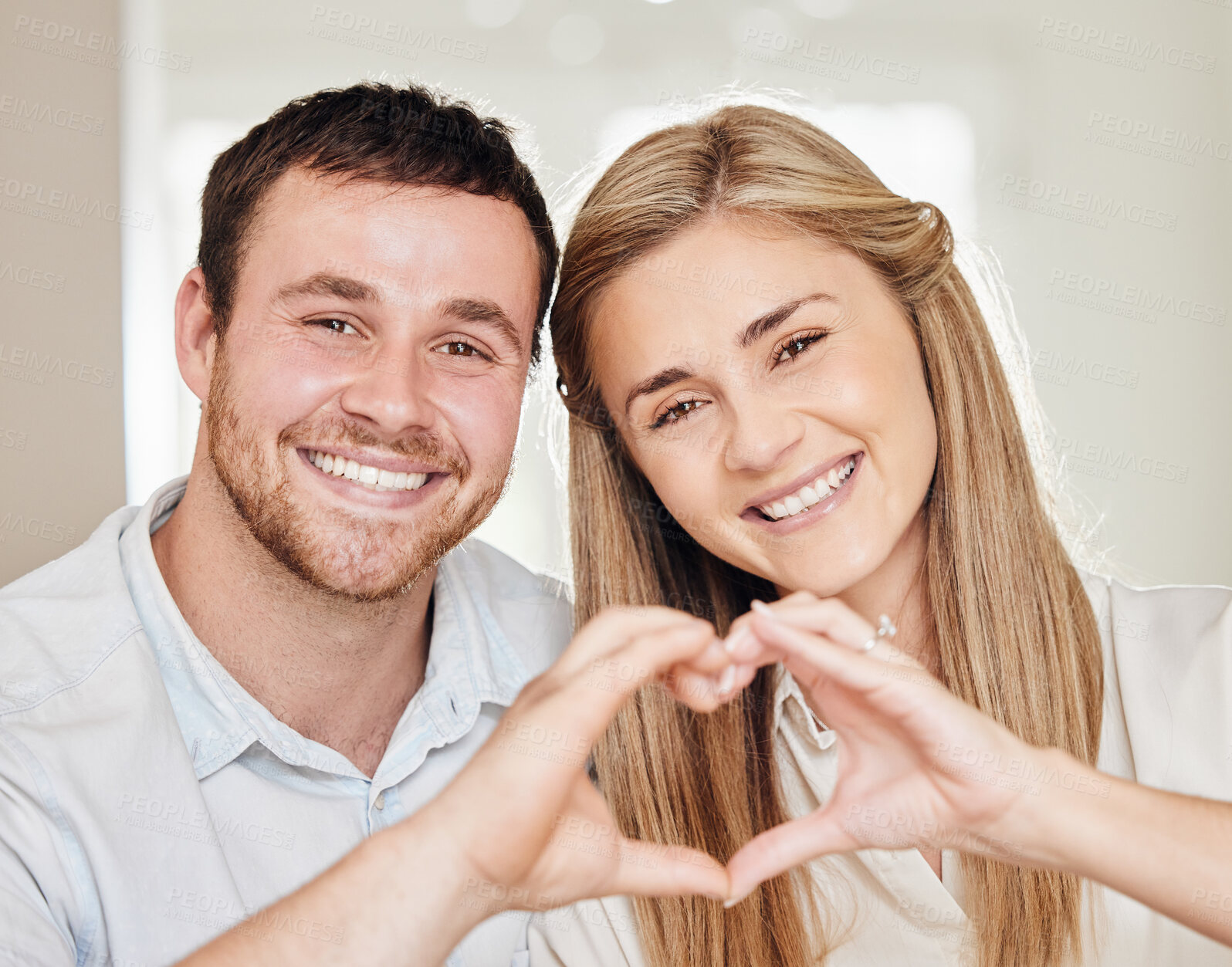 Buy stock photo Happy, heart and portrait of couple in home for bonding, loving relationship and commitment. Marriage, emoji and man and woman with hand sign on couch for love, affection and care in living room