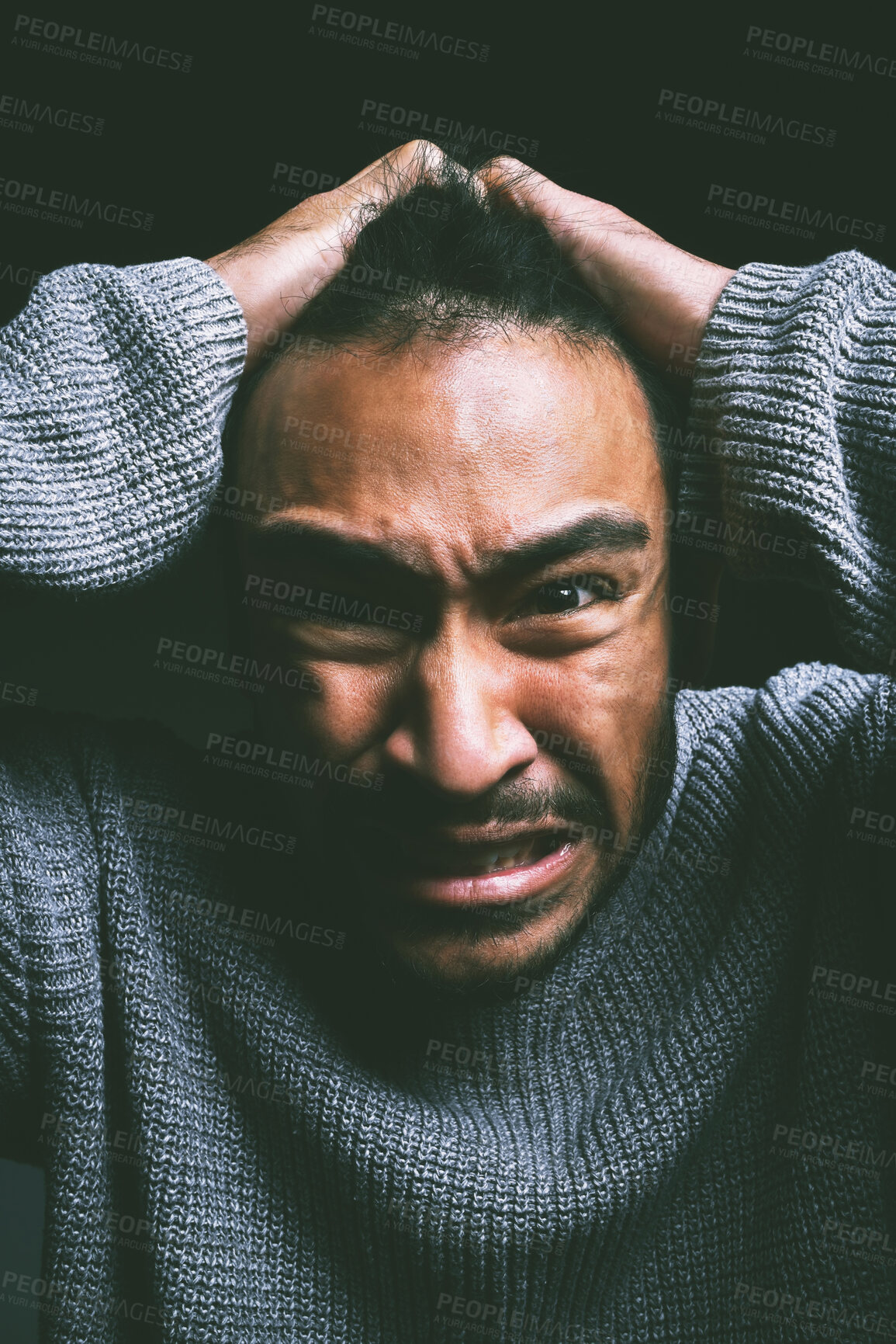 Buy stock photo Studio shot of a young man experiencing mental anguish and screaming against a black background