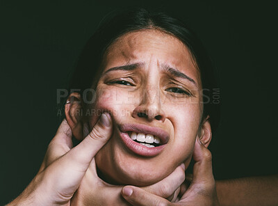 Buy stock photo Shot of hands grabbing a young woman’s neck against a dark background