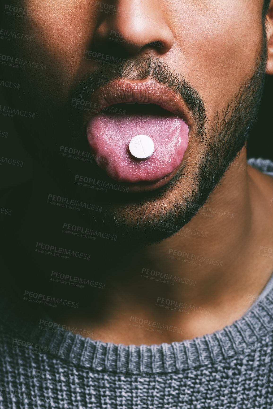 Buy stock photo Drug, mouth and man with tablet, in studio for medication, relief or healthcare on dark background. Tongue out, addict and male person taking medical supplement, vitamin pill or substance abuse