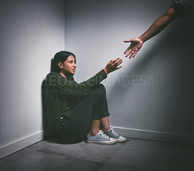 Buy stock photo Abuse, scared and woman with a hand of a person in a dark room for depression and mental health help. Horror, stress and a young girl reaching for hands for support from anxiety or trauma in a corner