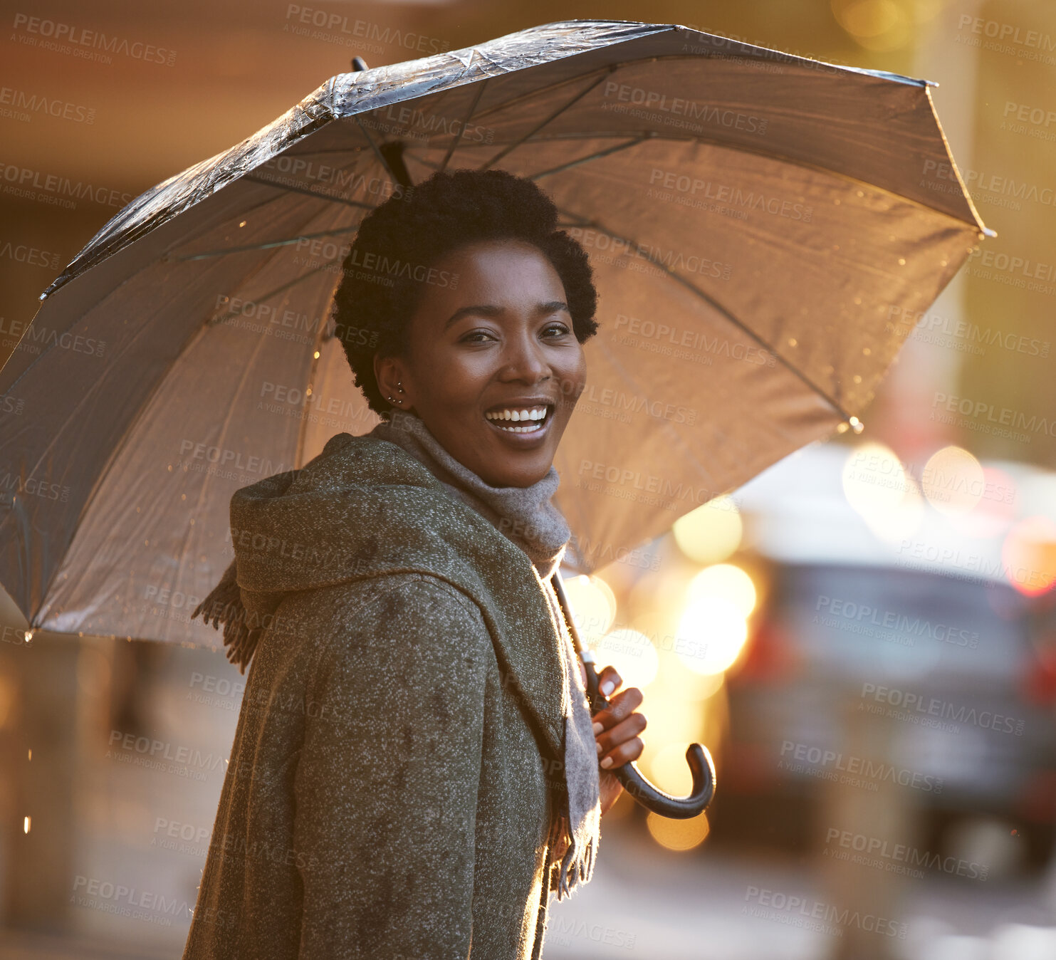 Buy stock photo Shot of a young businesswoman using an umbrella to cover with while going for a walk in the rain against an urban background