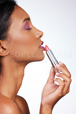 Buy stock photo Apply, lipstick and woman in studio for cosmetics, makeup and product for beauty. Profile, Indian female model and facial aesthetic for glowing, mouth treatment and relax by white background