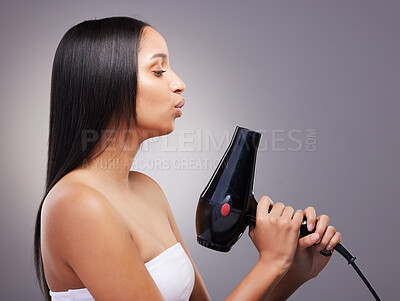 Buy stock photo Cosmetics, woman and hairdryer in studio grey background for wellness and self care. Female person, heat treatment and equipment isolated on backdrop for salon texture, style and keratin shine