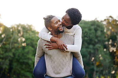 Buy stock photo Piggyback, kiss and happy black couple at park for anniversary date or honeymoon romance with smile. Wellness, hug and African people in nature with support, care and love on holiday fun in garden