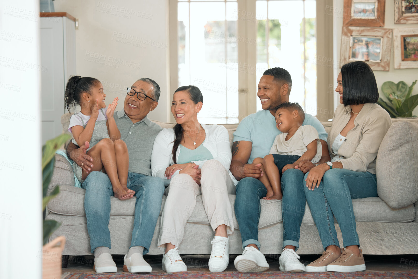 Buy stock photo Happy family, relax and together for reunion on sofa in living room for gathering, children and love. Support, celebrate and excited for holiday or vacation in home with kid and parents on couch 