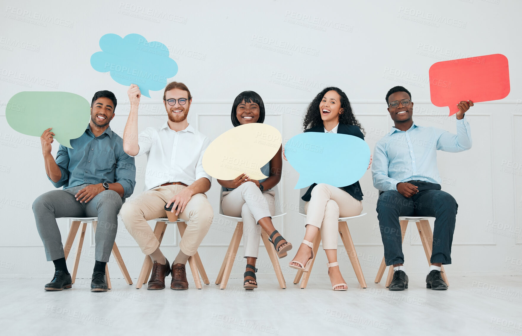 Buy stock photo Shot of a group of businesspeople holding speech bubbles while waiting in line at an office