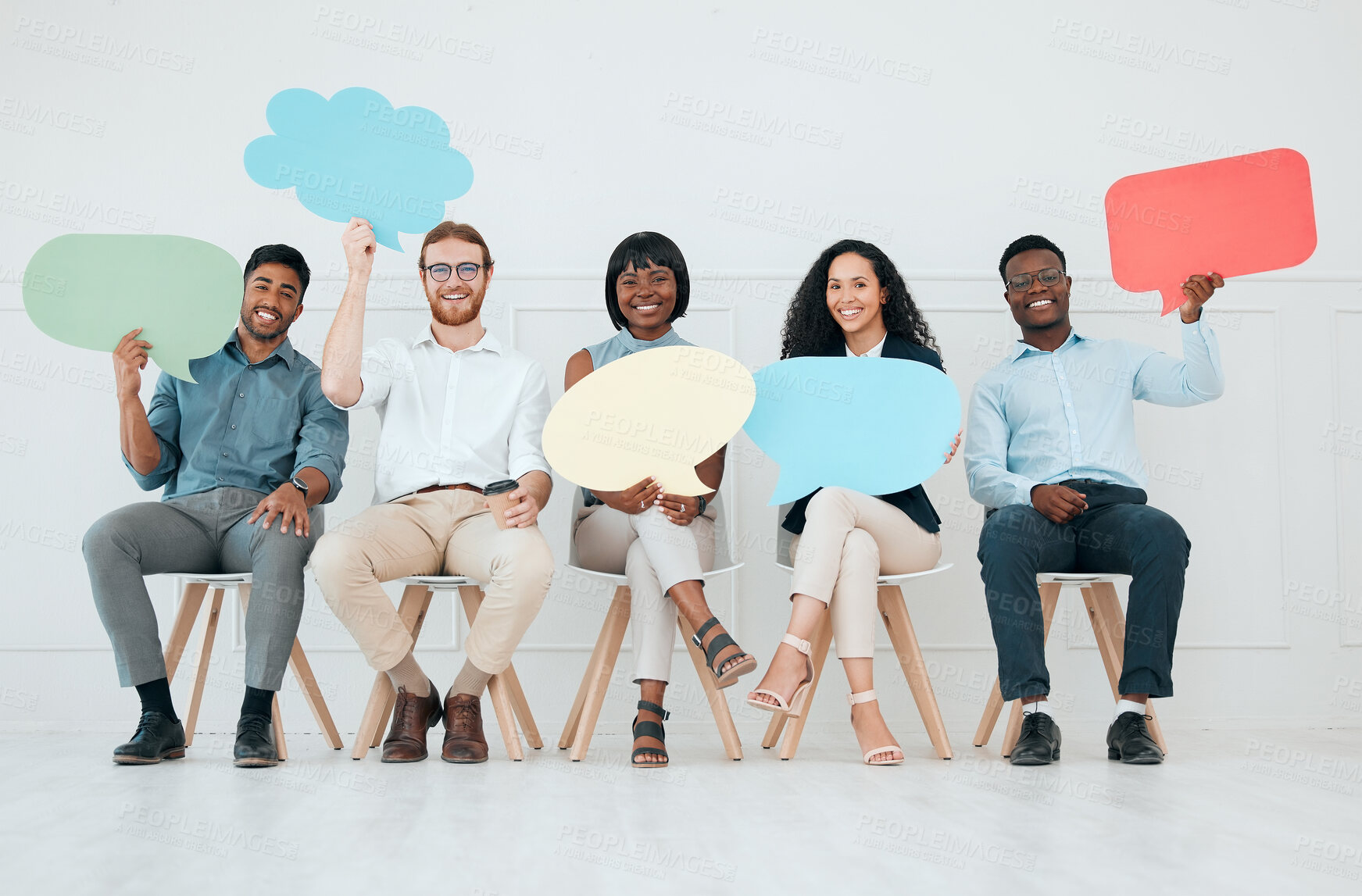 Buy stock photo Shot of a group of businesspeople holding speech bubbles while waiting in line at an office