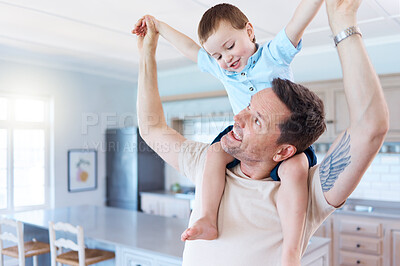 Buy stock photo Shot of a father and son palying in the lounge at home