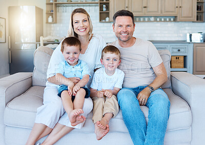 Buy stock photo Shot of a family sitting on the couch at home