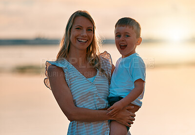 Buy stock photo Shot of a young mother spending time with her son at the beach
