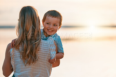 Buy stock photo Shot of a mother spending time with her son at the beach